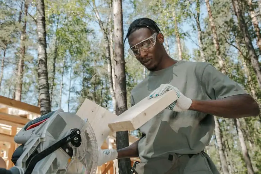A person showing how to cut 45 degree angle with a circular saw
