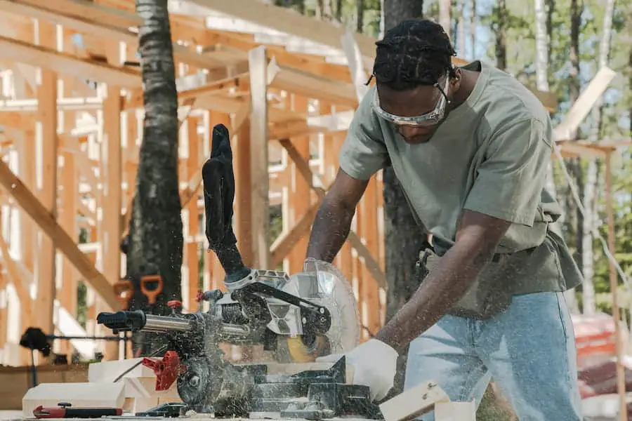 A man showing how to cut 45 degree angle with a circular saw