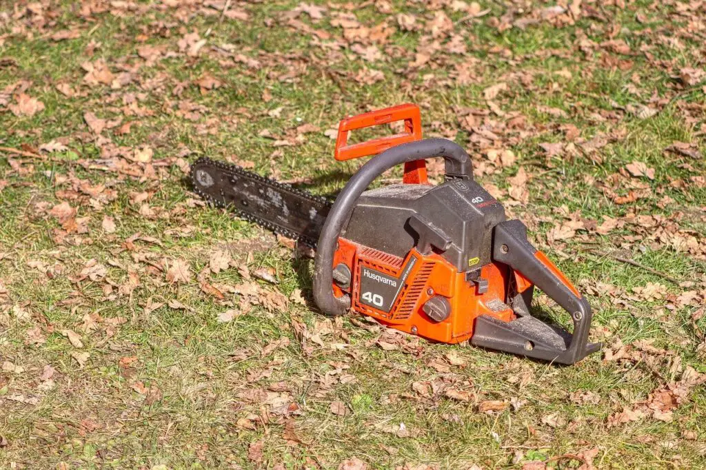 An image of a Husqvarna chainsaw on grassland