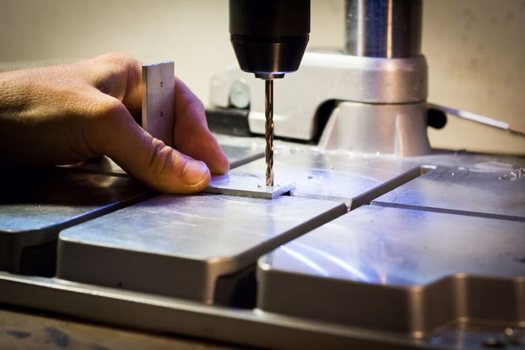 Hand drilling a hole in metal work