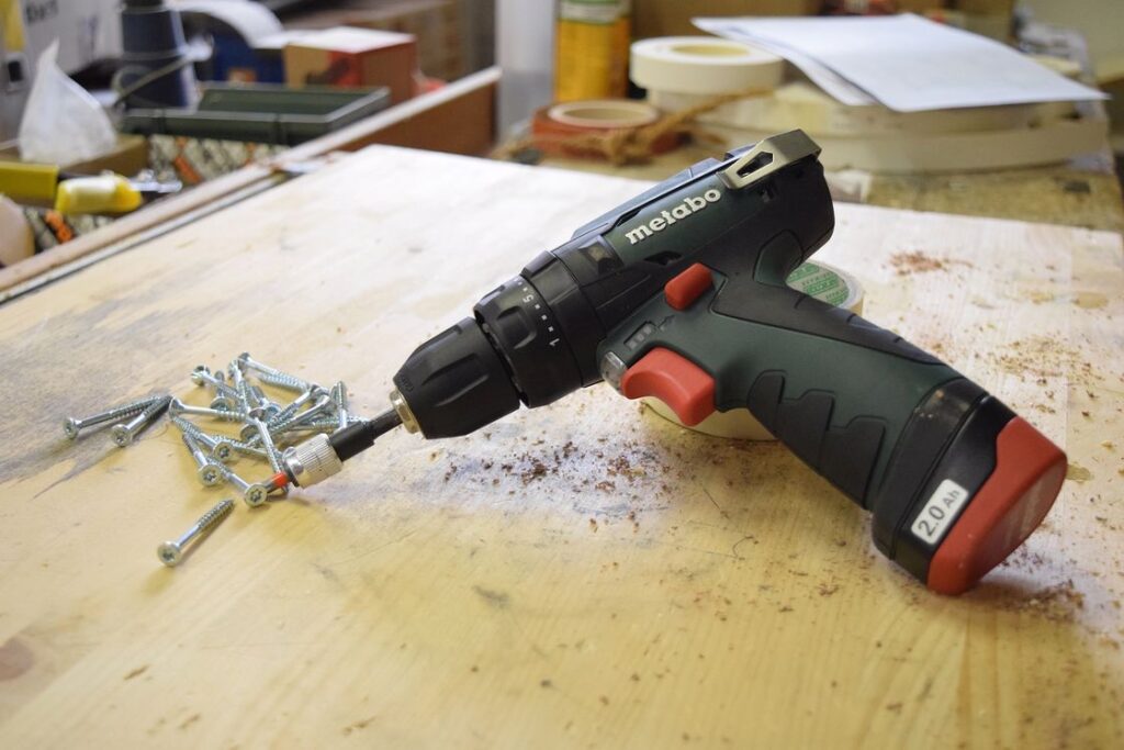 Cordless drill bits and screws placed on the table