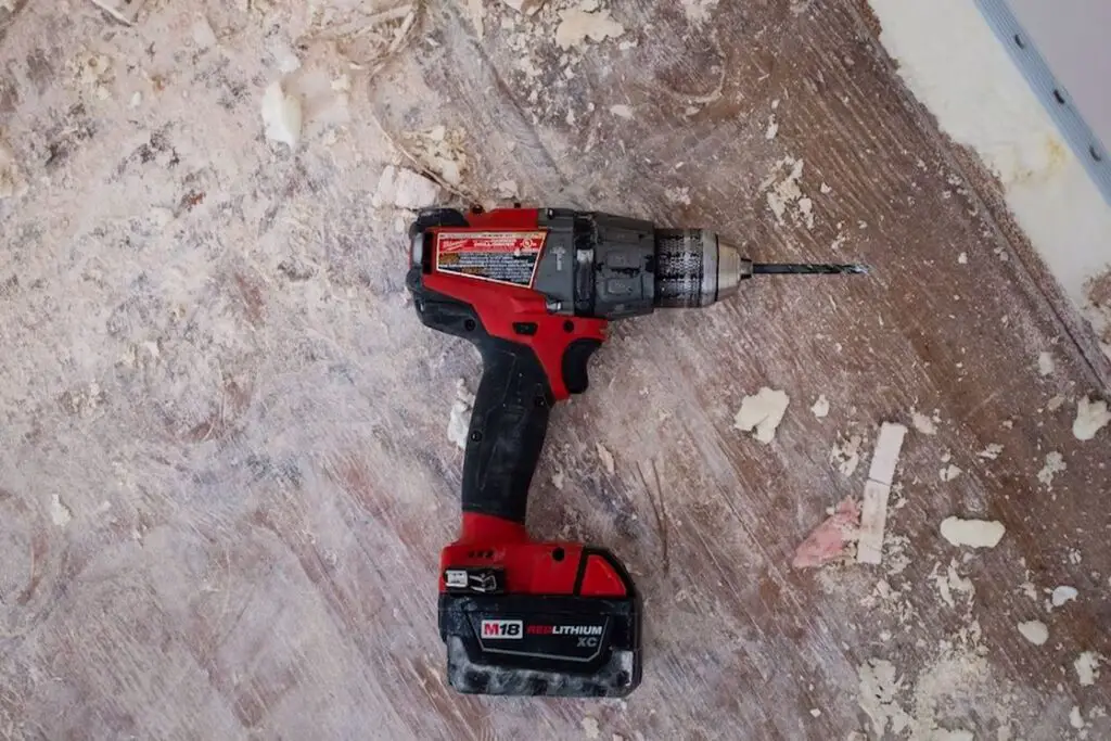 Red and black cordless drill on the floor