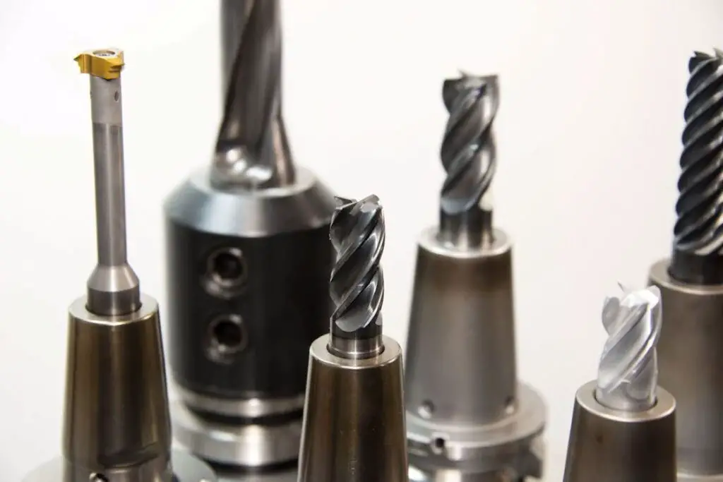 Six gray drill bits placed in upright positions
