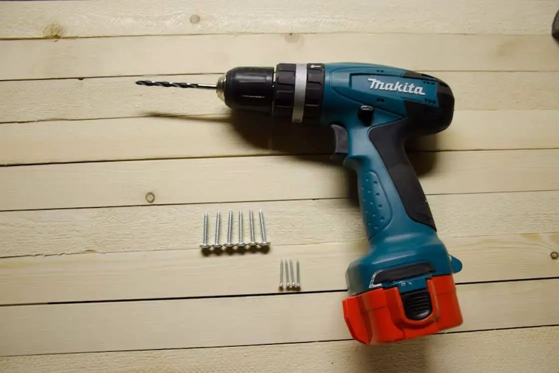 Cordless drill and screws on the table