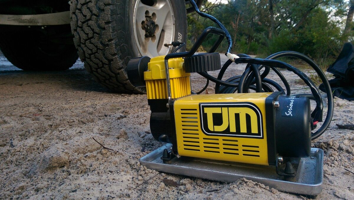 A yellow air compressor pumping a big tire