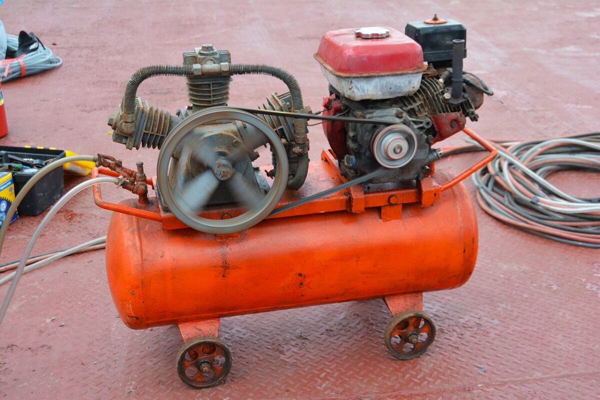 An old orange running air compressor