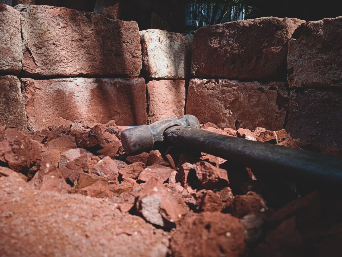 A steel hammer used in cutting bricks in the workplace.