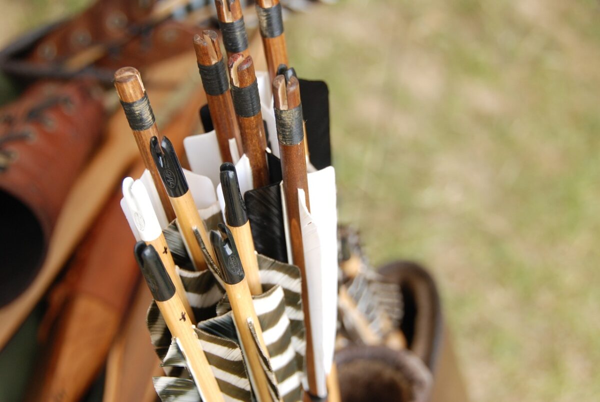 A set of brown and beige archery arrows in its quiver or holder